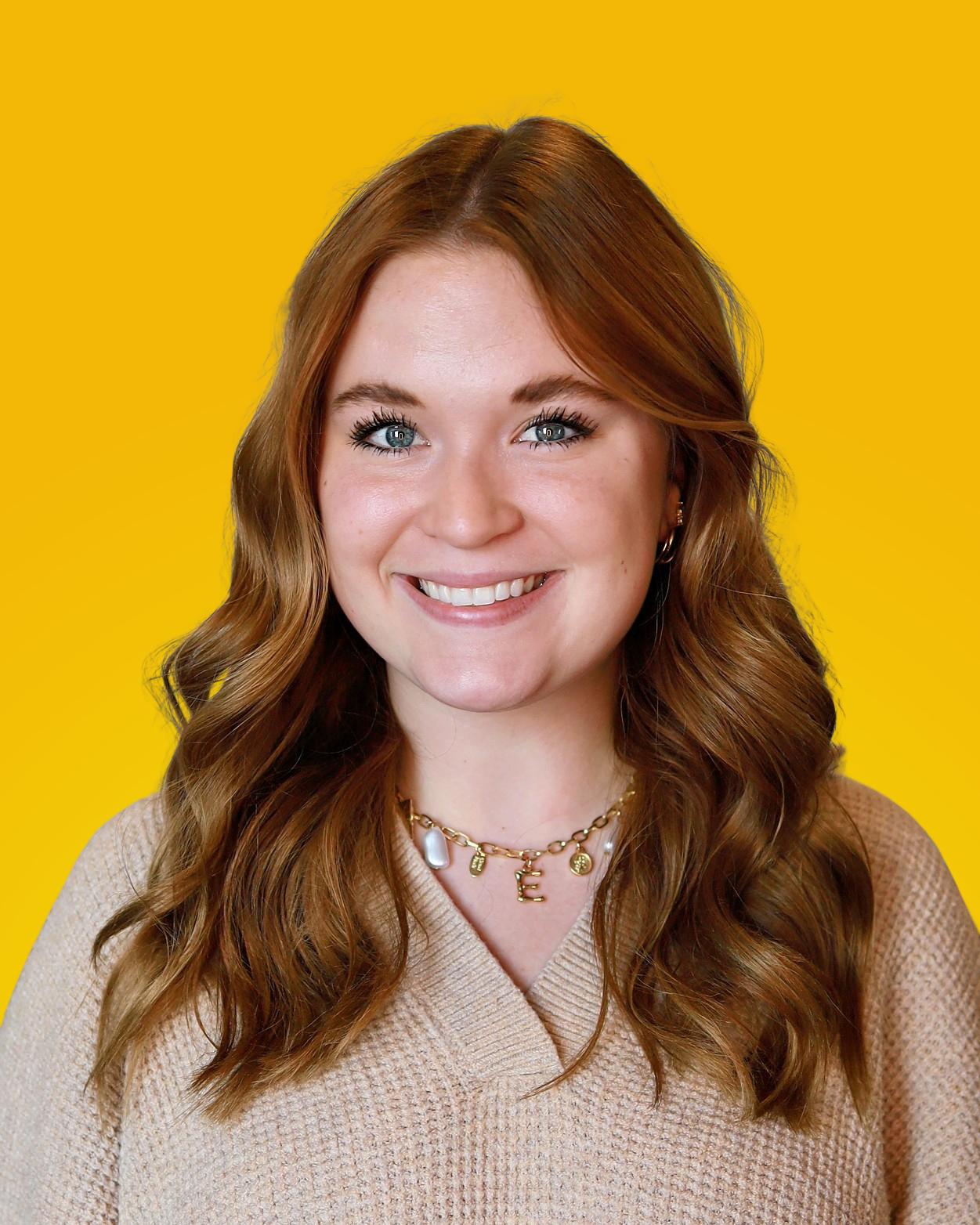 Professional headshot of a woman with glasses