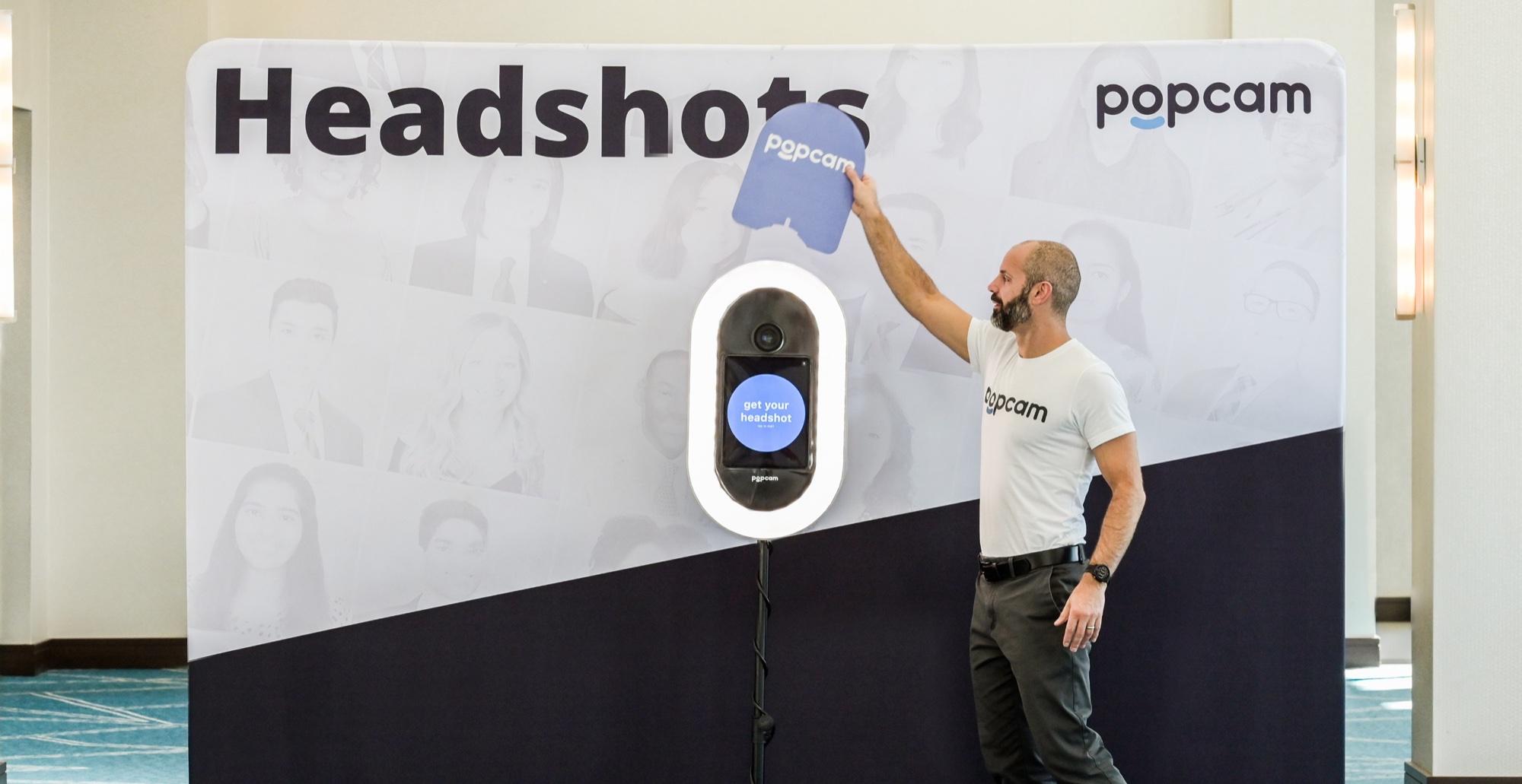 Popcam kiosk with a branded Headshots backdrop