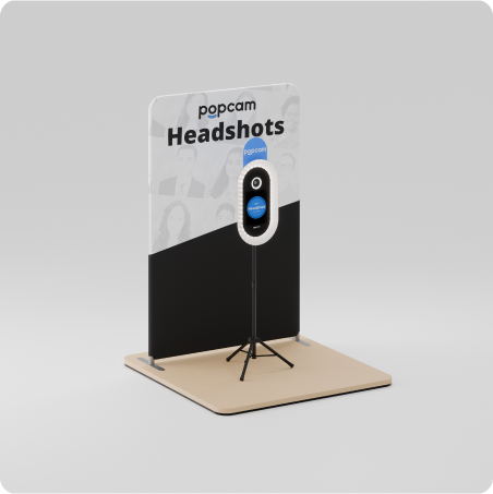 Popcam kiosks in front of a branded Headshots backdrop